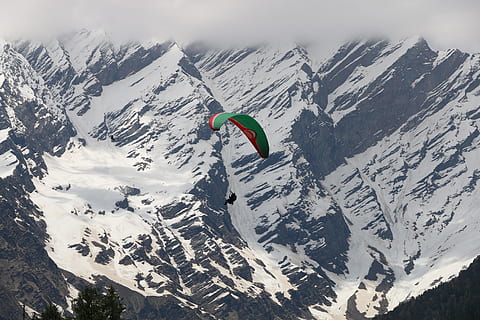 person paragliding above snowy mountains during daytime, Paragliding in Solang Valley HD wallpaper