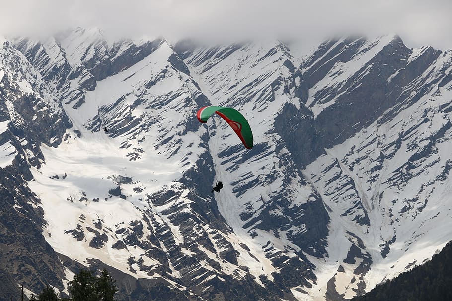 person paragliding above snowy mountains during daytime, Paragliding in Solang Valley HD wallpaper