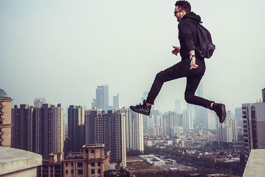 man jumping building gap, people, flying, sky, aerial, fog HD wallpaper