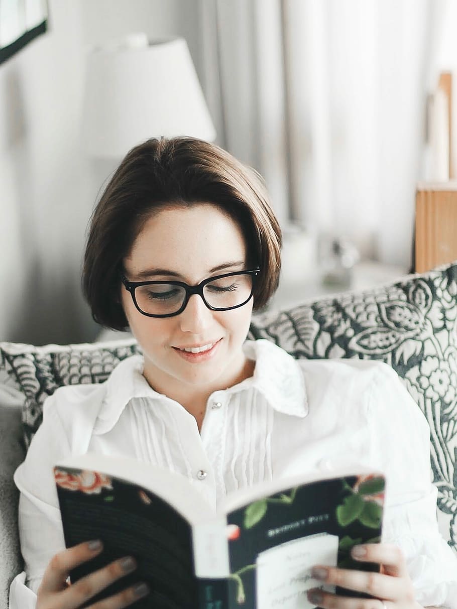 woman in black eyeglasses while reading book, woman holding book, HD wallpaper