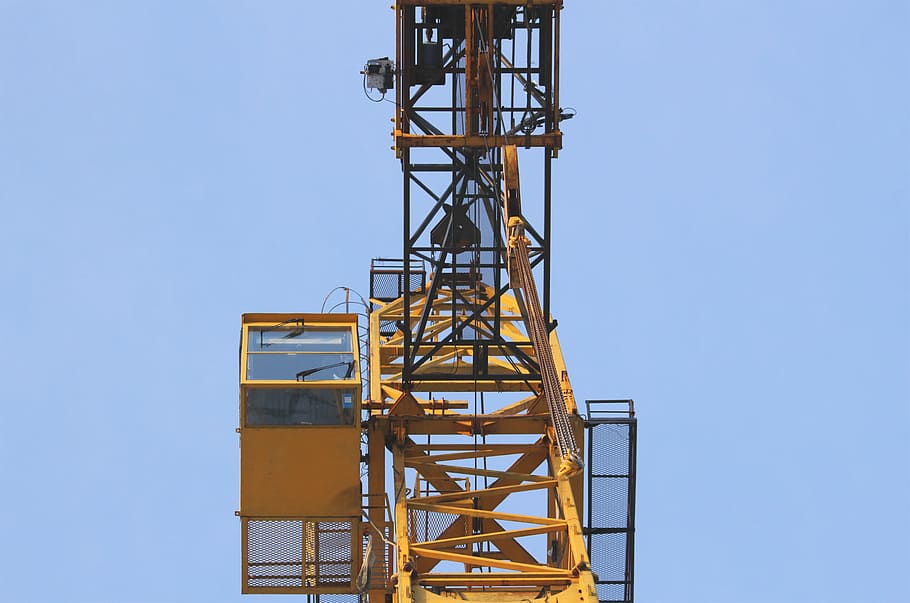 yellow mobile crane control center during daytime low-angle photo HD wallpaper