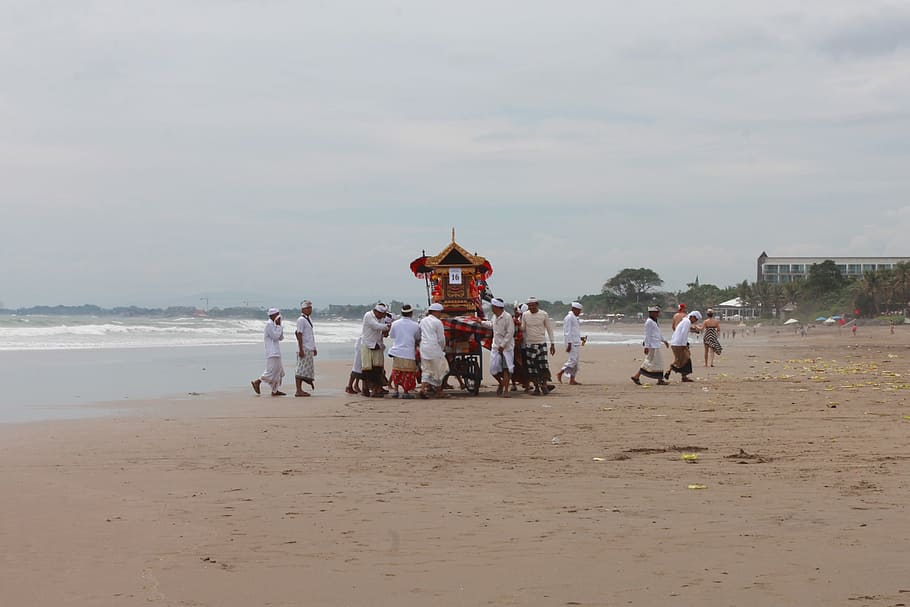 people standing near shoreline, balinese, ceremonial, traditional