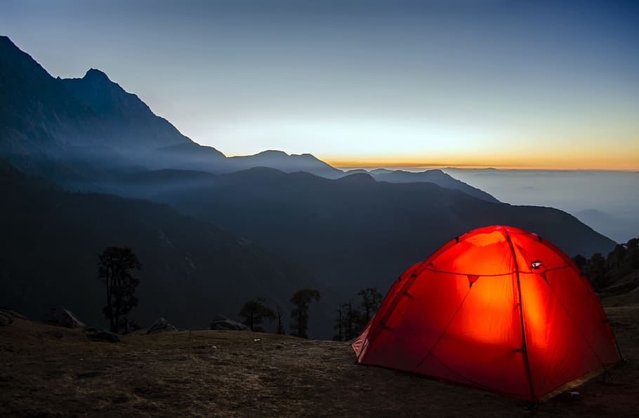 red dome tent fronting mountain range, camping, travel, sunrise