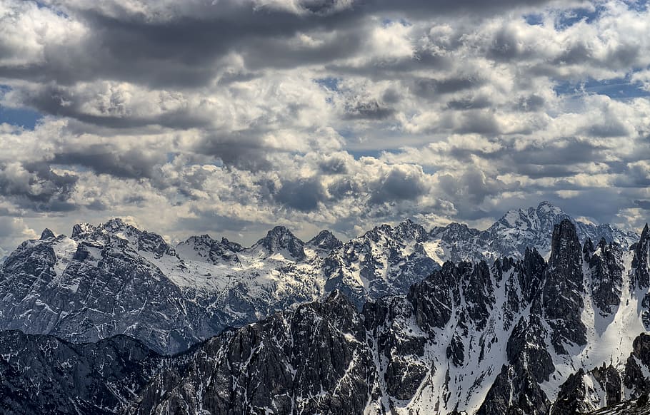 snow-covered mountains under cloudy sky, Auronzo di Cadore Dolomites Italy