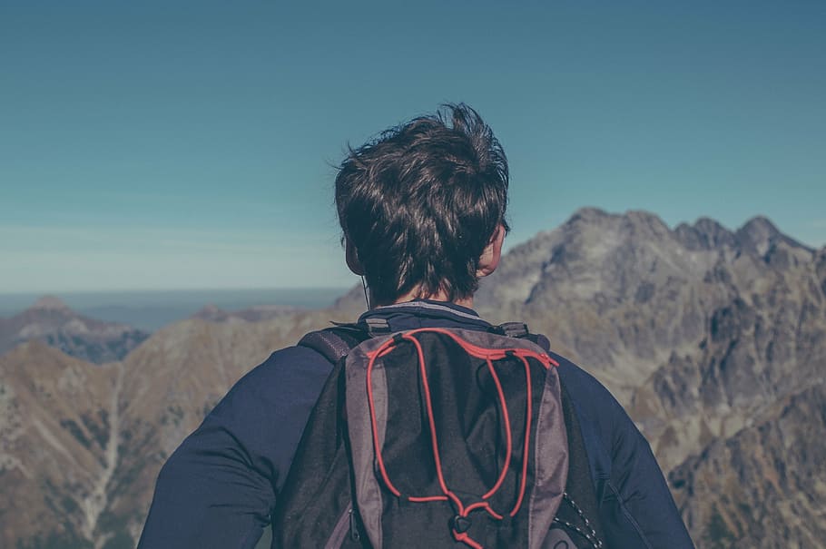 man seeing brown mountains taken at daytime, black, hiking, backpack