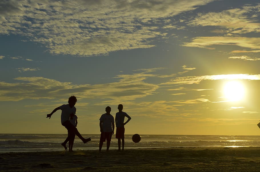 silhouette photo of people playing ball at the seashore, football