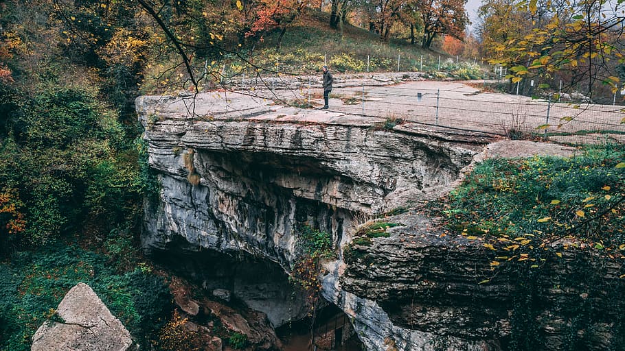 Person Standing on Gray Concrete Road, autumn, cliff, daylight HD wallpaper