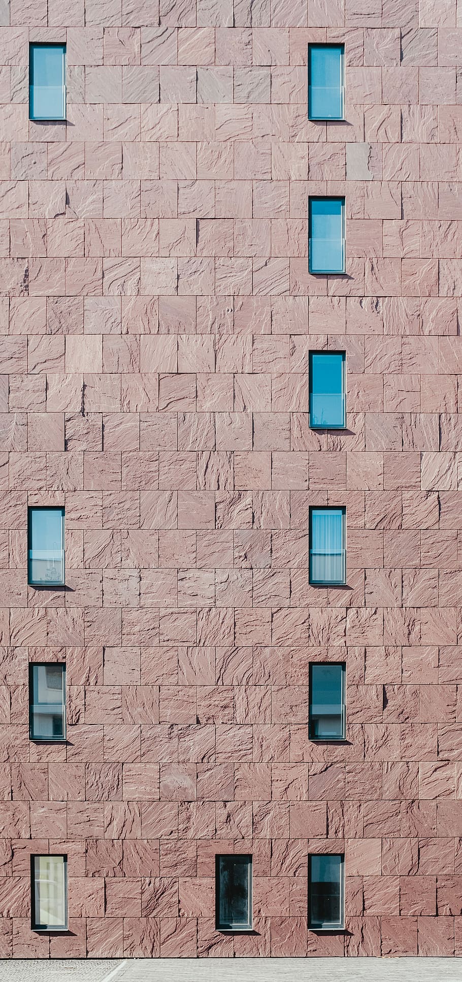 brown concrete building, panoramic photography of brown brick wall with glass windows HD wallpaper