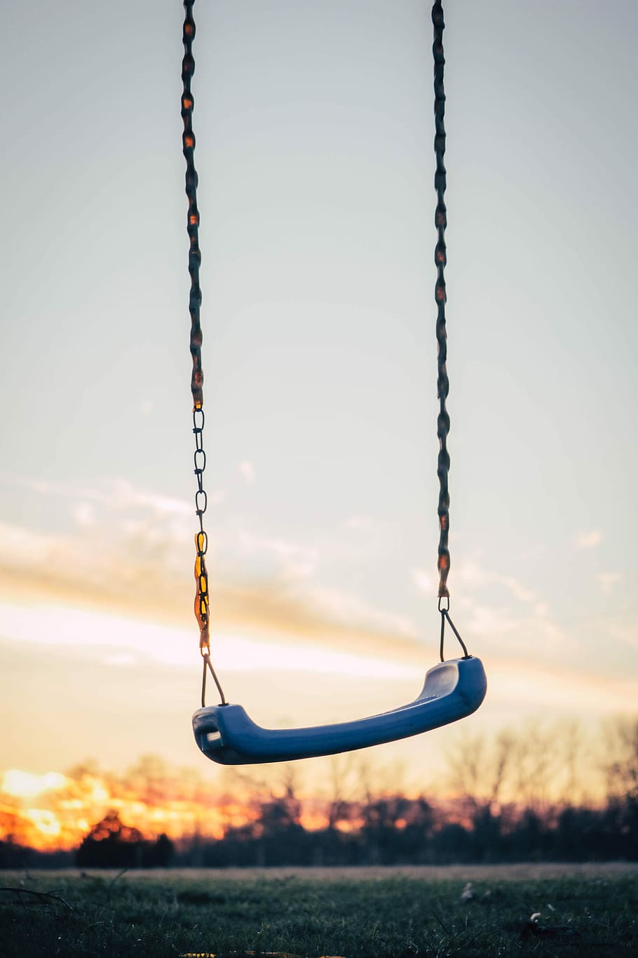 selective photography of blue plastic swing, blue and gray play swing