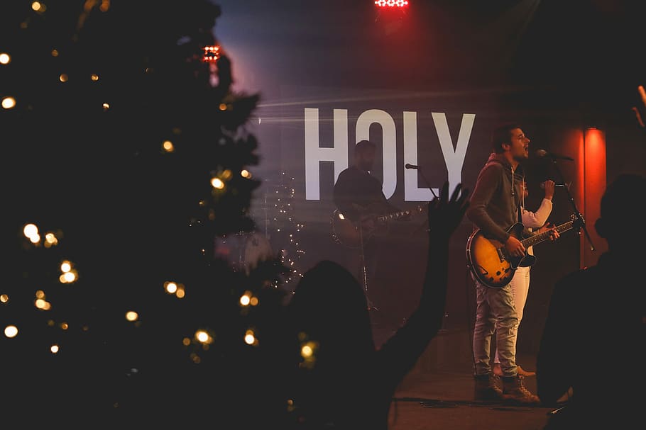 man performing on stage, man holding brown and black guitar in front of microphone HD wallpaper