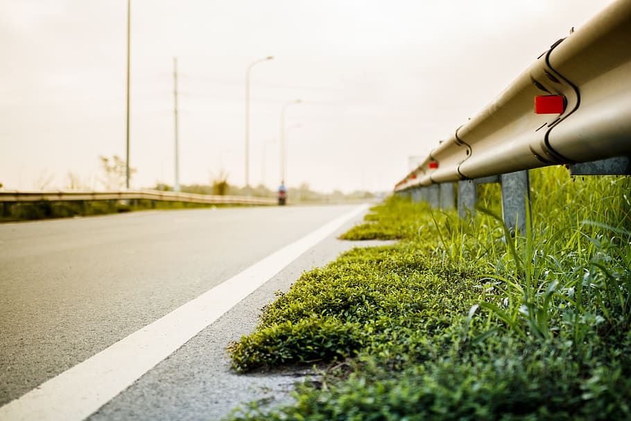 green grass beside fence, barrier, blur, empty, low, road, road side HD wallpaper