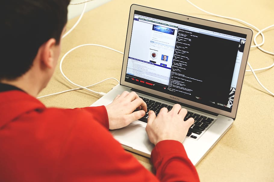 man in red jacket typing on MacBook Air, programming, developing, HD wallpaper