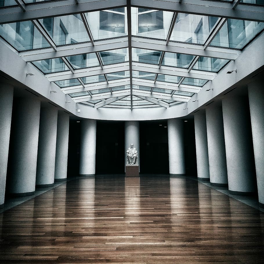 architectural photography of modern building with glass roofing, statue in the middle of columns indoor HD wallpaper