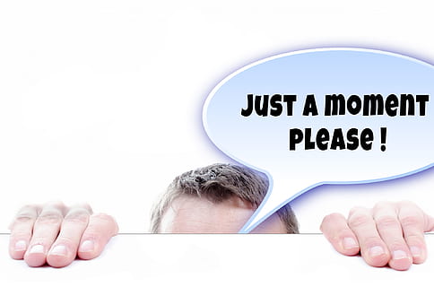 person's forehead and hands with just a moment please! bubble chat HD wallpaper