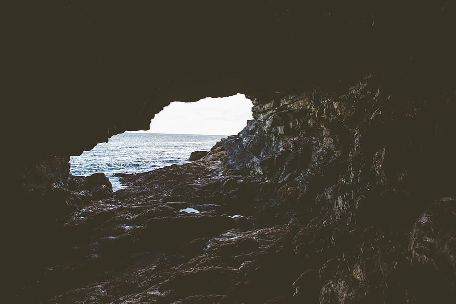 cave beside body of water, brown, near, rocks, coast, cliff HD wallpaper