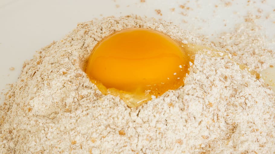 shallow focus photography of egg yolk on beige grain, flour HD wallpaper