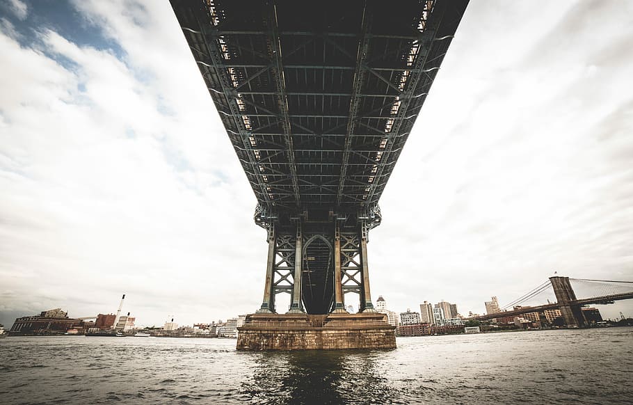 grey steel bridge over sea under grey and blue sky, bridge under cloudy sky HD wallpaper