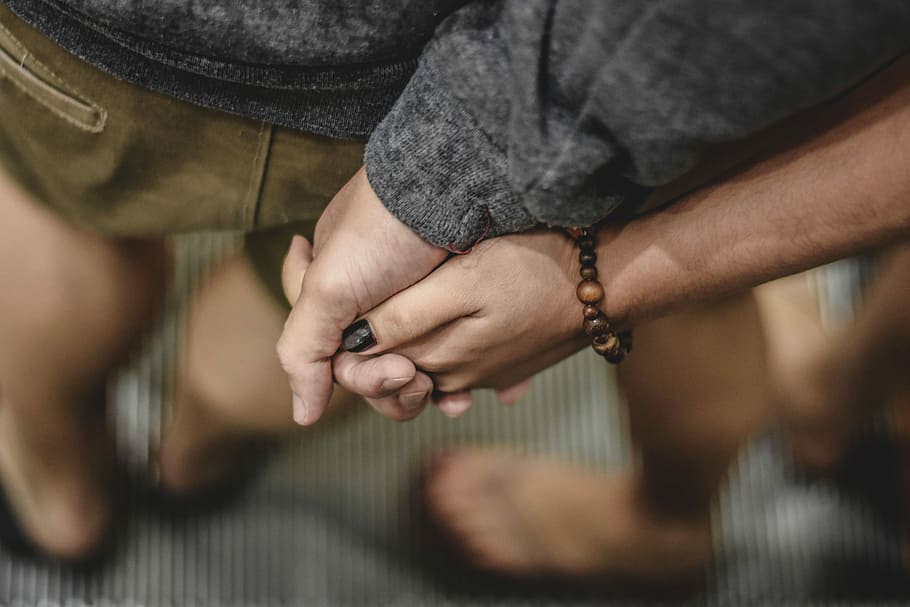 two person holding hands selective focus photography, two person holding hands HD wallpaper
