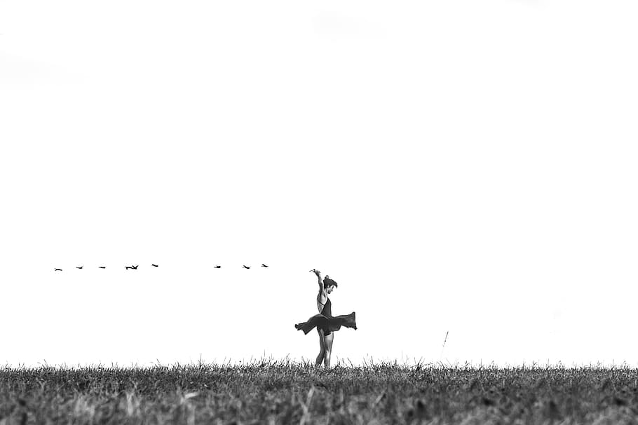greyscale photo of woman standing on grass field, grayscale photo of woman at the middle of field HD wallpaper