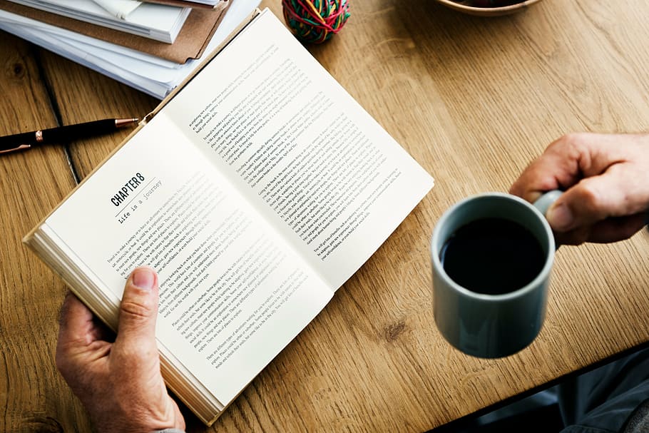 person holding mug and opened book, table, read, knowledge HD wallpaper