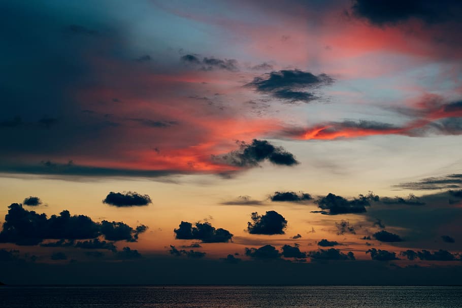 low angle photo of black clouds during golden hour, body of water under dark clouds HD wallpaper