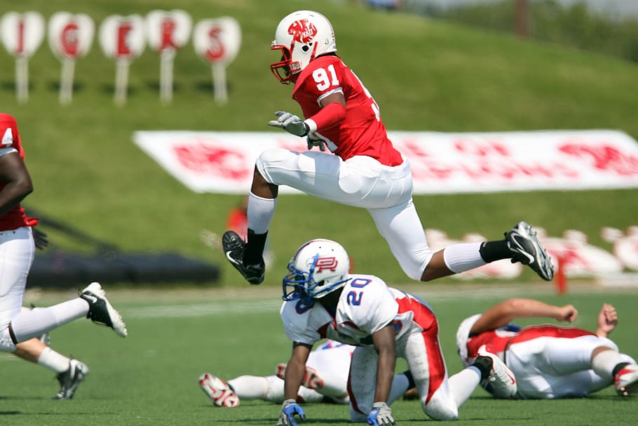 NFL player jumping during the game, american football, football player