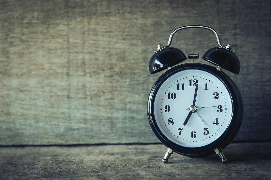 round black and white analog alarm clock on brown wooden rack HD wallpaper
