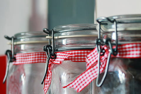 selective focus photography of three clear glass air tight canisters near wall HD wallpaper