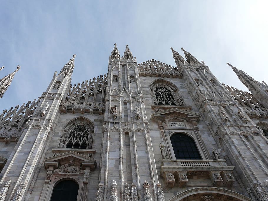 low angle photography of gray cathedral under white sky during daytime HD wallpaper