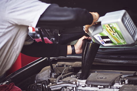 man refilling motor oil on car engine bay, person filling gasoline on engine bay HD wallpaper
