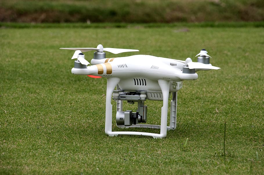white quadcopter on lawn, white DJI Phantom 3 Professional on green grass HD wallpaper