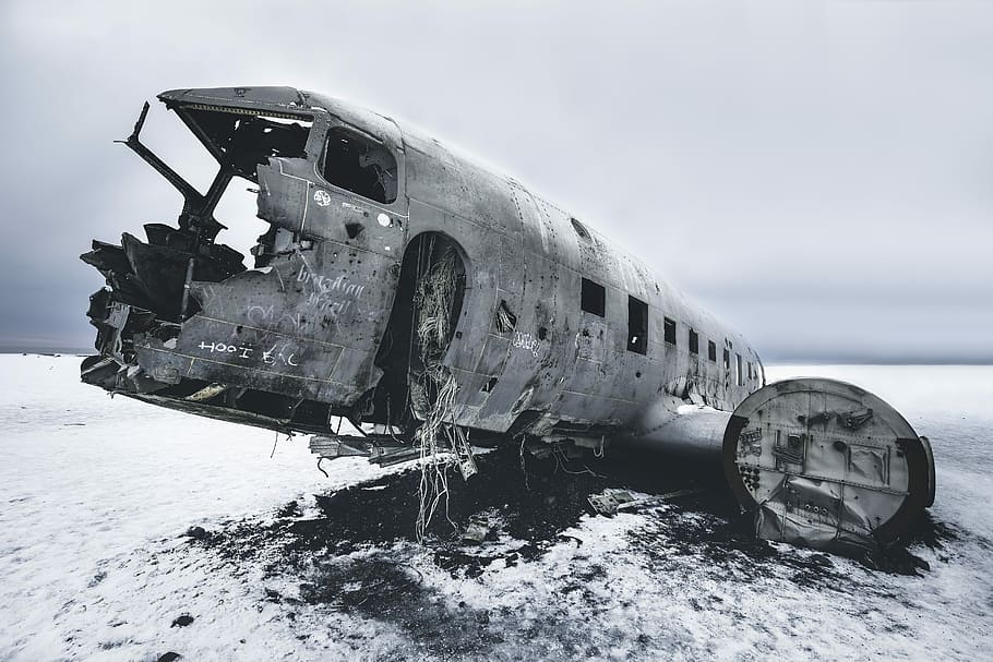 grayscale photography of abandoned airliner, crashed airplane on open field