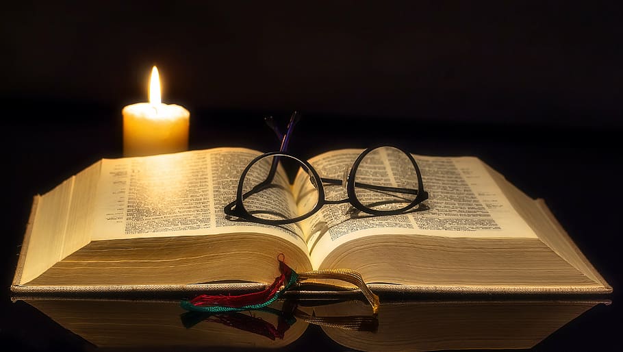 eyeglasses with black frame on white book, bible, open, reading glasses