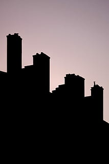 silhouette of chimneys, silhouette of buildings under gray skies HD wallpaper