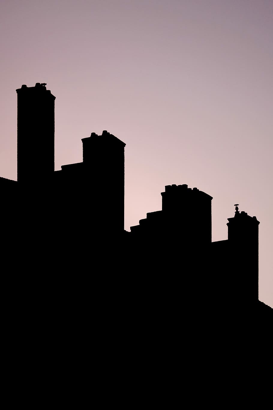 silhouette of chimneys, silhouette of buildings under gray skies HD wallpaper