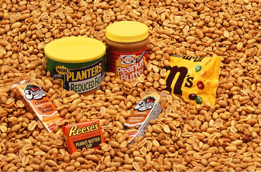 assorted chocolate product lot surrounded with nuts, peanuts