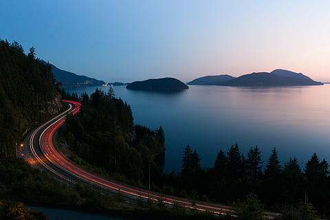 aerial time-lapse photography of highway near sea, aerial photo of road near sea during nighttime HD wallpaper