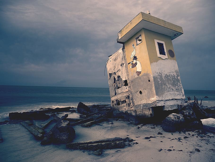 brown concrete house under gray clouds, abandoned gray concrete house on seashore near sea HD wallpaper