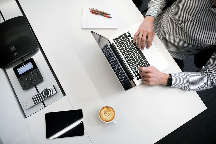 person using laptop on white wooden table, flat lay photography of MacBook Pro, teacup, and black iPad HD wallpaper