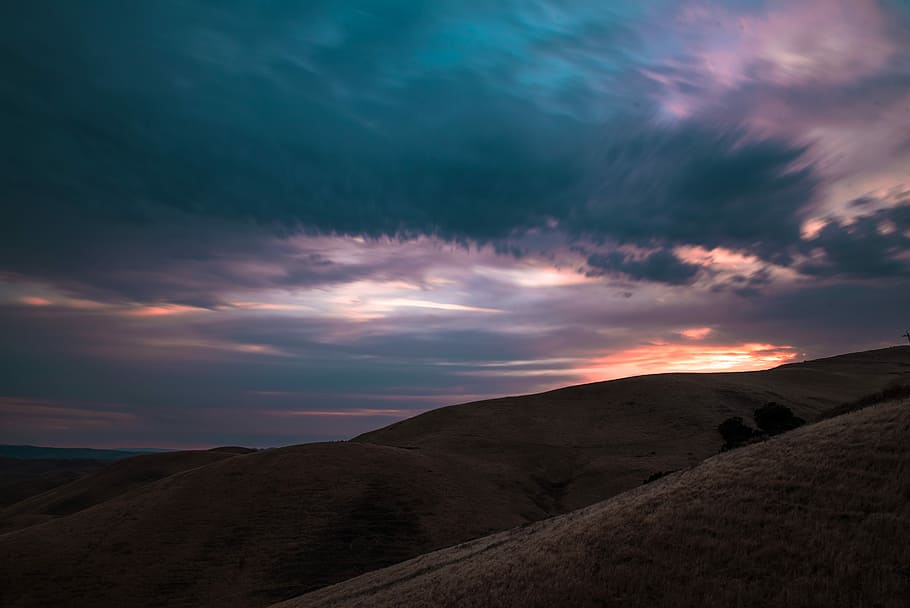 mountain under blue sky photography, brown mountains under cloudy sky during sunset HD wallpaper