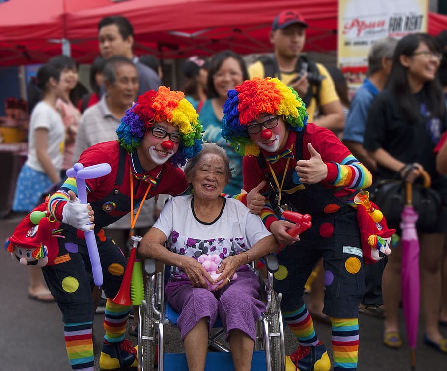 woman on wheelchair in between two clown in festivity during daytime, HD wallpaper