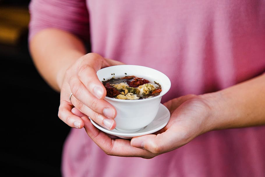 Warm me up, tilt-shift lens photo of person holding white ceramic bowl and saucer HD wallpaper