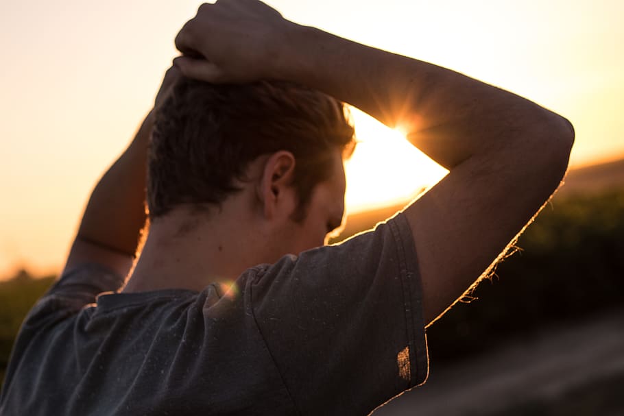 man holding his hair against sunlight, Ponder, caucasian, golden hour