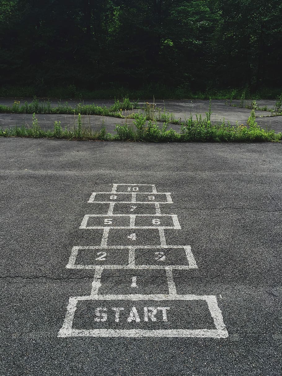 numbering start line on concrete floor, gray vehicle park, hopscotch