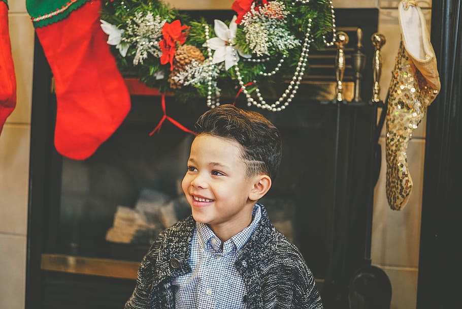 boy wearing gray collared top, boy smiling below Christmas decors HD wallpaper