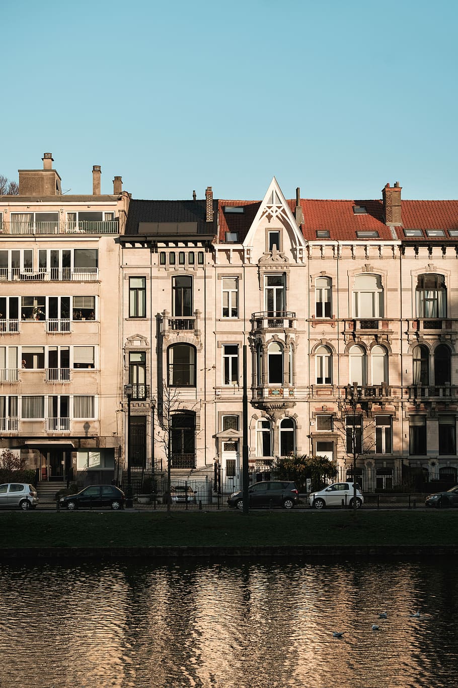 Houses by a lake and park in Brussels, Belgium, white concrete buildings in front of body of water HD wallpaper