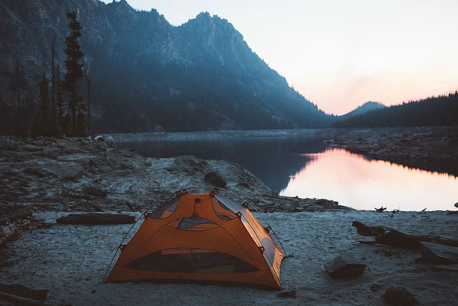 orange and gray camping tent near body of water, orange tent near body of water during morning