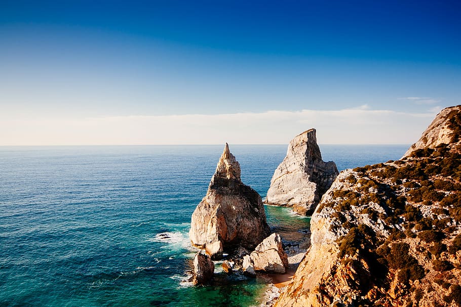 rock formations on sea at daytime, cliff and body of water landscape photography HD wallpaper