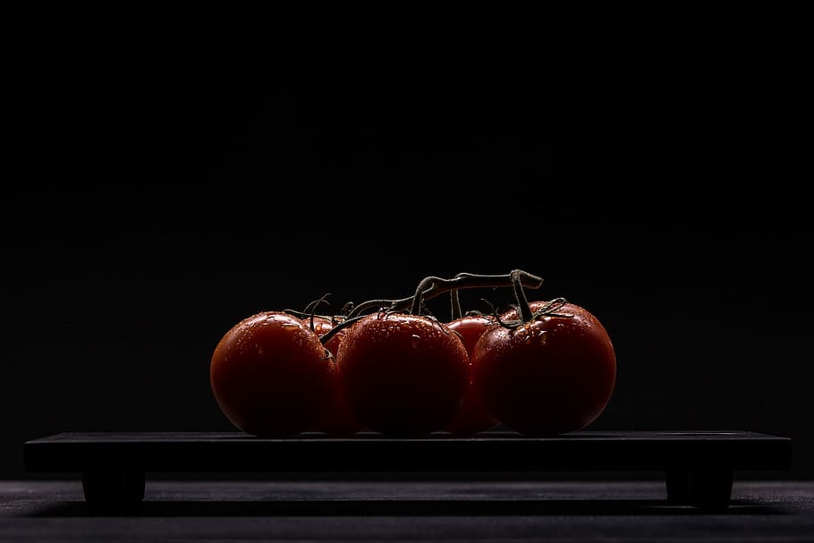 red tomatoes on black surface, five red tomato fruits on black table HD wallpaper