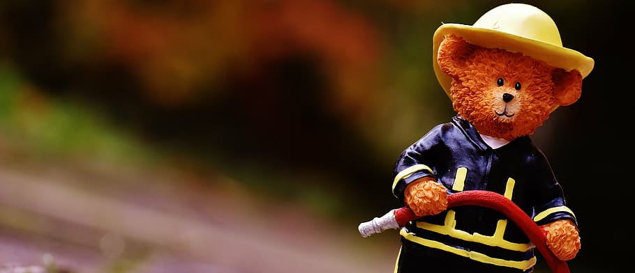 selective focus photography of brown ceramic fireman bear figurine HD wallpaper